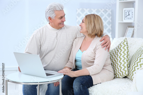 Grandparents using laptop a...