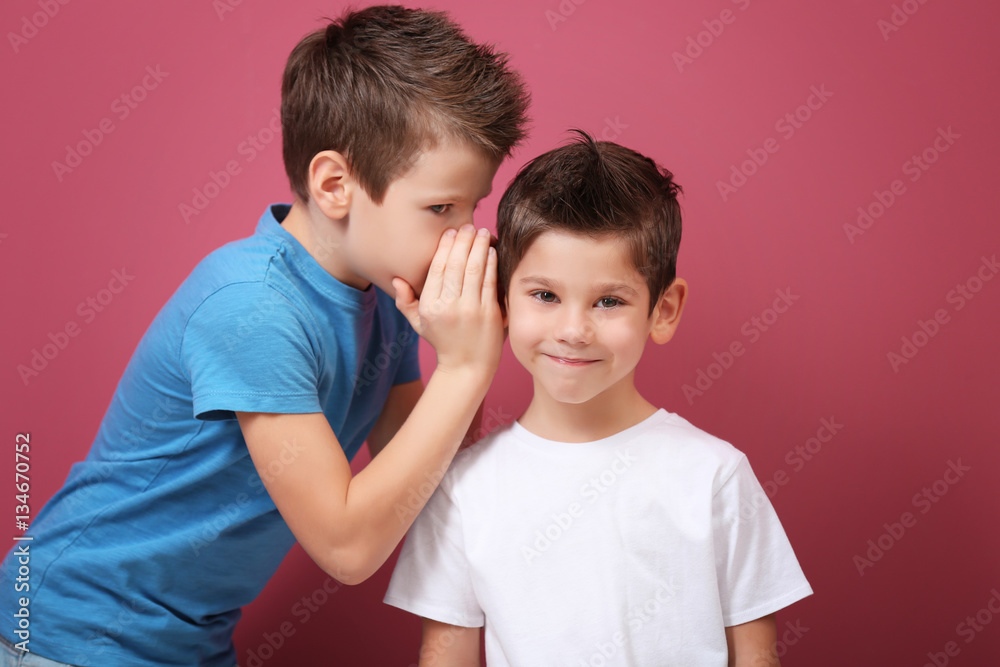 Cute little brothers standing on pink background Cute little brothers standing on pink background