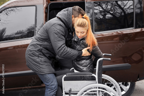 Young man helping handicapp...