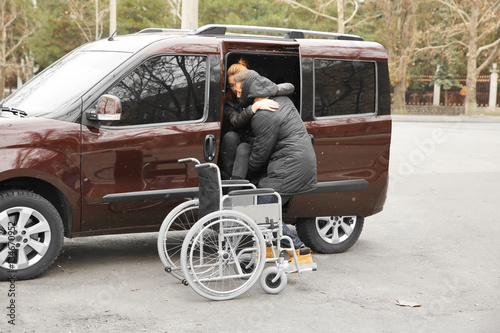 Young man helping handicapp...