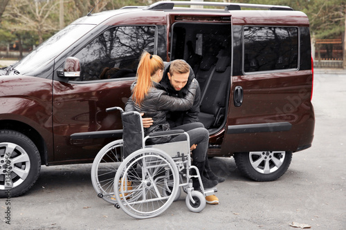 Young man helping handicapp...