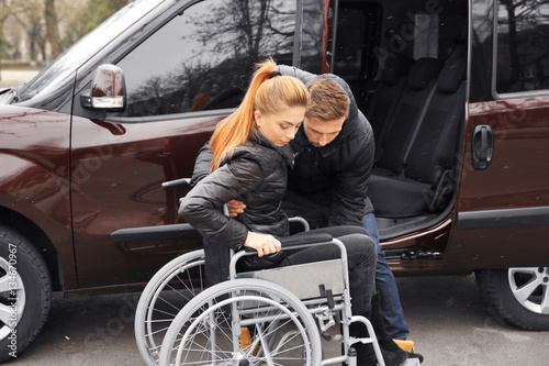 Young man helping handicapp...