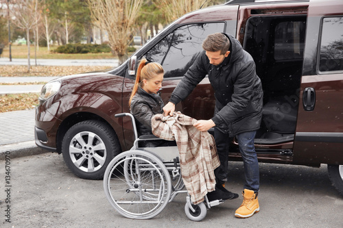 Young man helping handicapp...