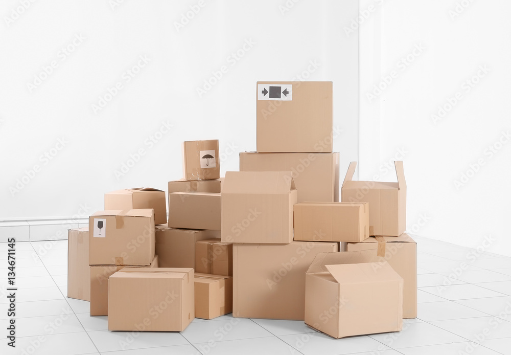 House move concept. Carton boxes on white wall background
