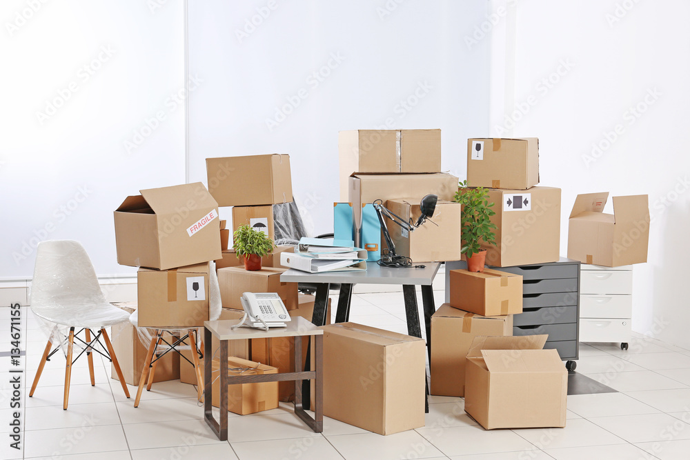 Move concept. Unpacking cardboard boxes in a new office Move concept. Unpacking cardboard boxes in a new office