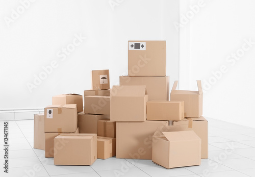 House move concept. Carton boxes on white wall background © Africa Studio