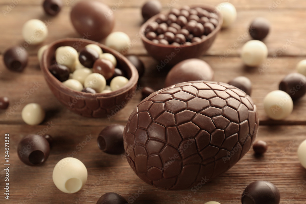 Chocolate Easter eggs and sweets on brown wooden background Chocolate Easter eggs and sweets on brown wooden background