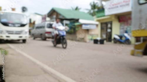 blur in  philippines  people   walking and riding motorbike traffic jam center town .