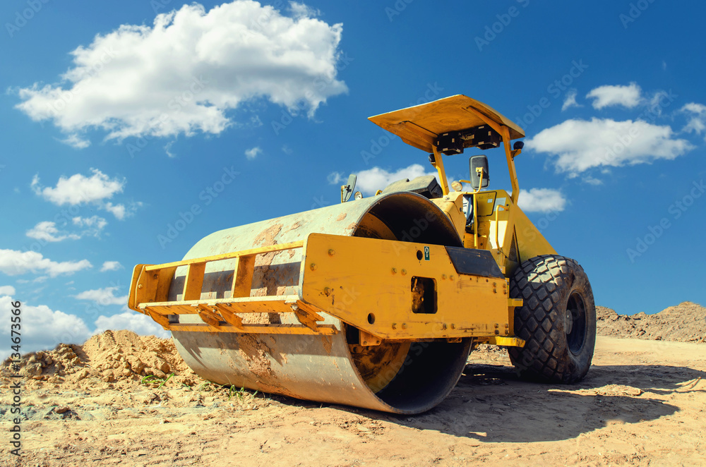 Construction asphalt roller closeup and blue sky background Construction asphalt roller closeup and blue sky background