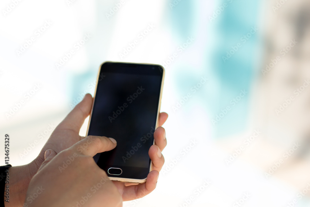 Closeup of female hand using a smart phone. Shallow depth of fie Closeup of female hand using a smart phone. Shallow depth of fie