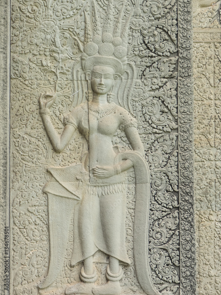 Stone carving of an angel or Apsara on the wall of Angkor Wat, the 12th century Hindu temple complex in Cambodia
