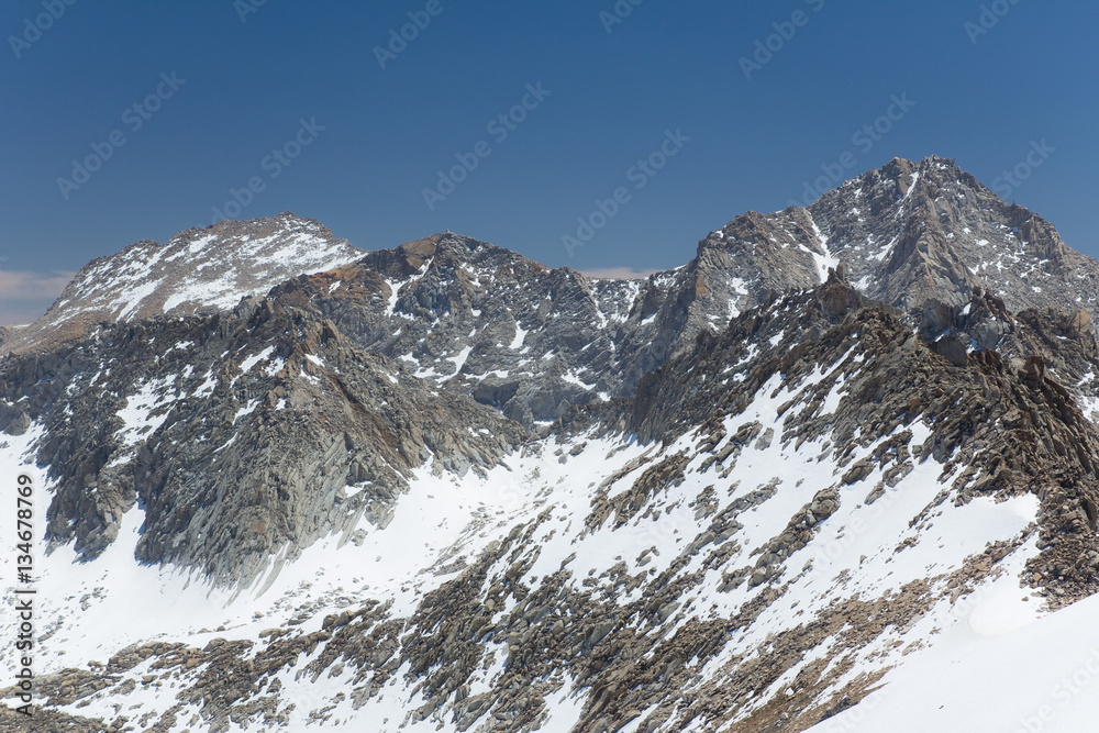 Snow covered granite peaks and cliffs during Spring in California's Sierra Nevada mountains