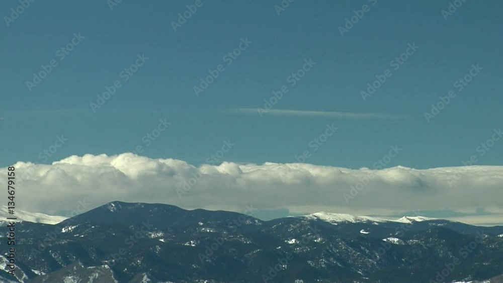 Rotor and Wave Clouds over Snow Capped Rockies Rotor and Wave Clouds over Snow Capped Rockies