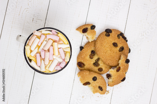 Cup of hot cocoa  with color marshmallow and oatmeal cookies