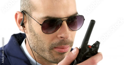 Security guard talking on walkie talkie on white background 4k