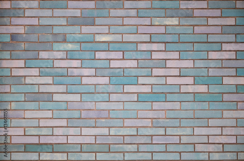 The texture of wall from a variety of old and dirty brick. Detailed pattern of a plurality of different sizes of brick colored worn out