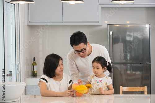 asian family cooking at kitchen