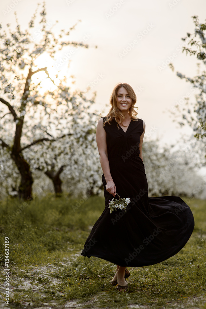 Beautiful young woman in spring garden