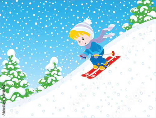 Small child skiing down the snowy hill