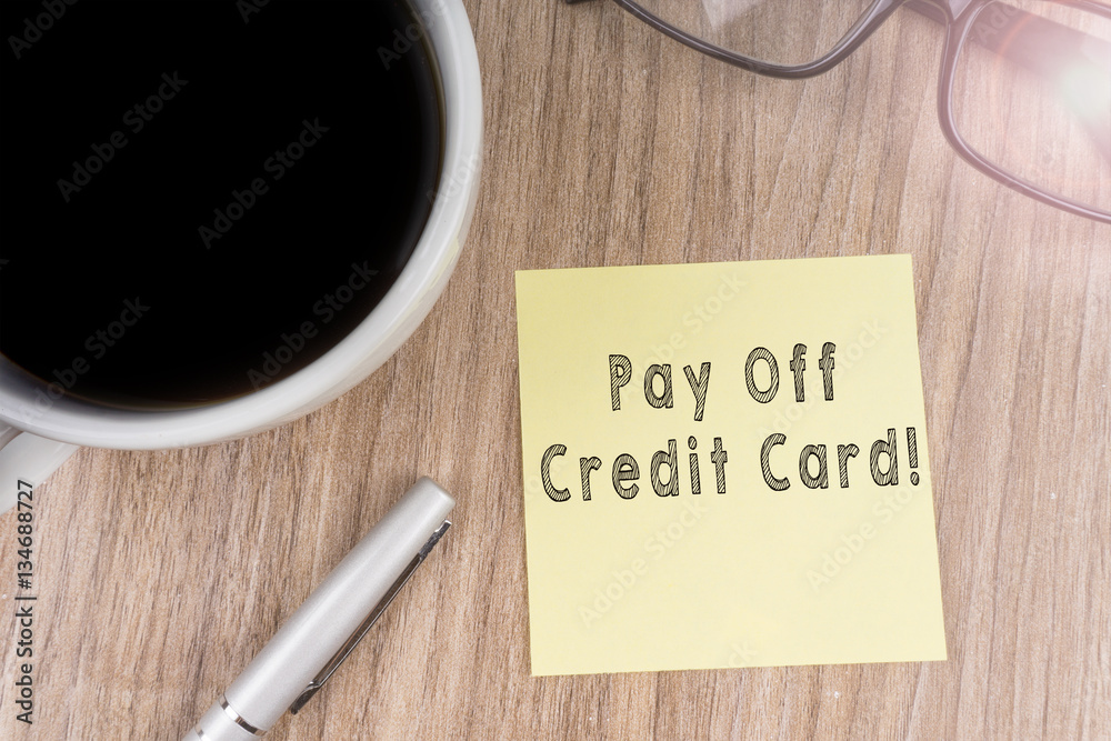 PAY OFF CREDIT CARD! text on yellow note PAY OFF CREDIT CARD! text on yellow note