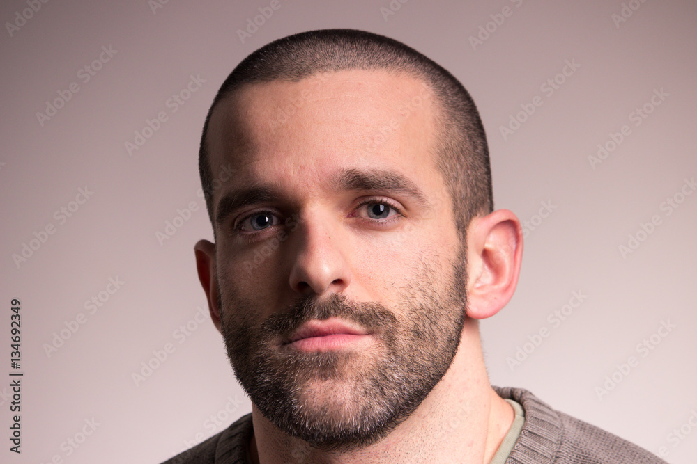 young sad man, closeup, looking at camera, face head young sad man, closeup, looking at camera, face head