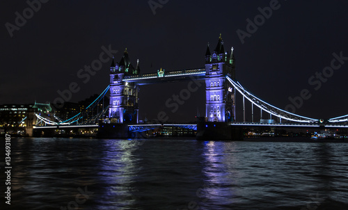 The famous Tower Bridge from London, England reflected in water photo