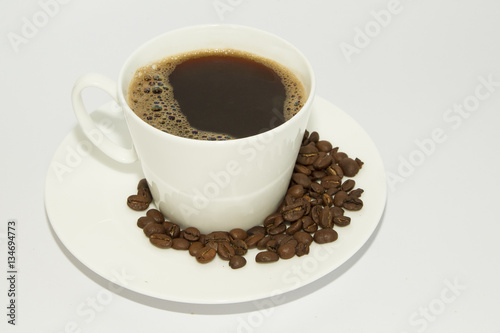 White cup of coffee with saucer on white background
