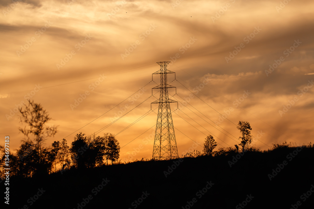 high voltage pole on the top of mountain with golden sky