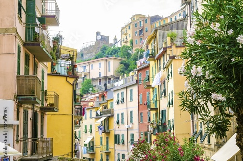 Riomaggiore village  La Spezia  Liguria  northern Italy. Colourful houses on steep hills castle with clock laundry on balconies.Part of the Cinque Terre National Park and a UNESCO World Heritage Site.