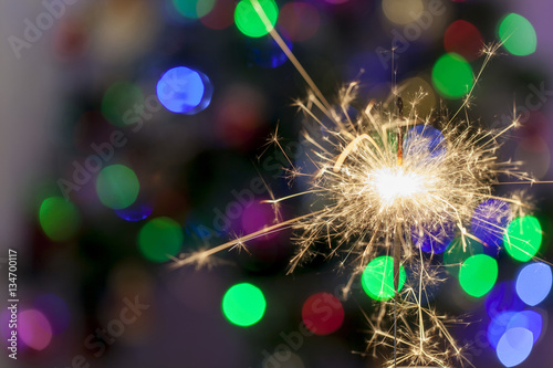 New Year s sparkler with bokeh lights on the background