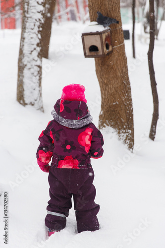 Little girl stands in winter