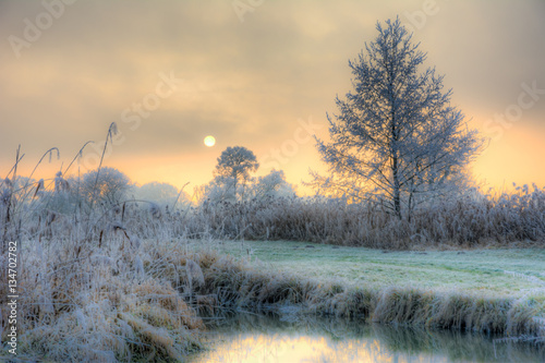 Sunset on a foggy winter day at the river Paar photo