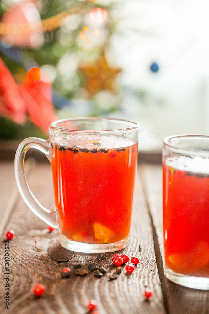 Hot Christmas Drink with Christmas Tree on the Background, Vertical View Hot Christmas Drink with Christmas Tree on the Background, Vertical View