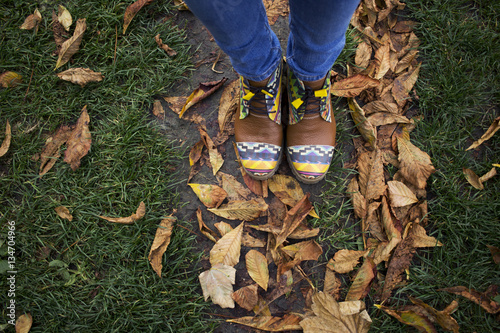 Aerial view on feet in the leaves