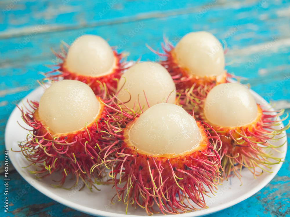 Closeup of peeled rambutans served on white dish-Selective focus Closeup of peeled rambutans served on white dish-Selective focus