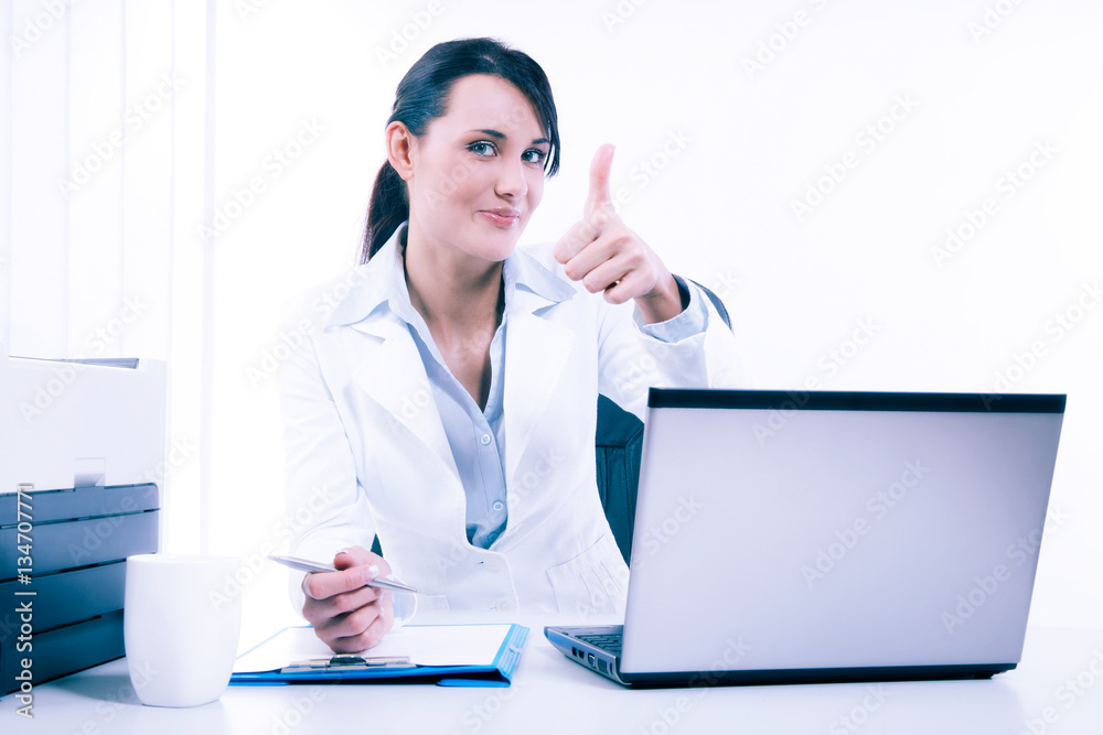 Young attractive business woman using laptop at the office Young attractive business woman using laptop at the office