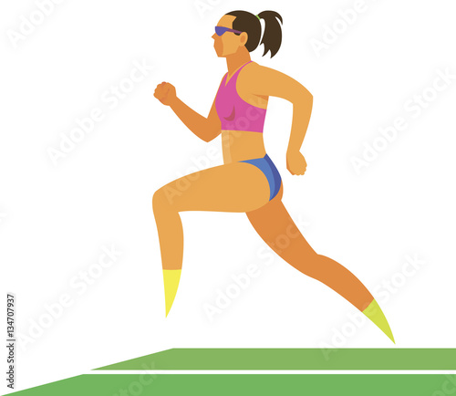Young slim woman sprinter runs rapidly along the track
