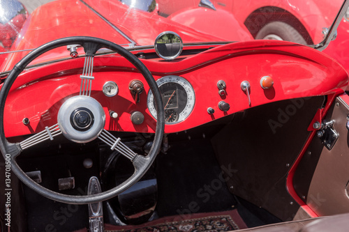 Retro style classic red car interior with matching dashboard