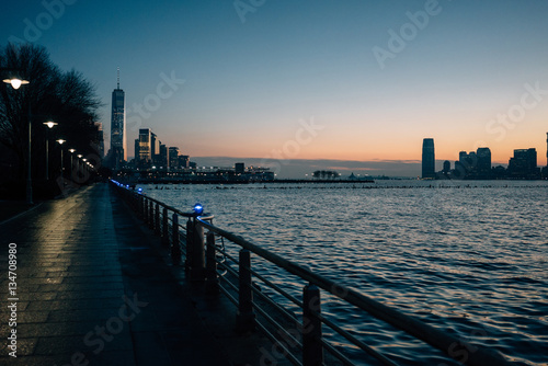 Waterfront promenade and modern buildings at night