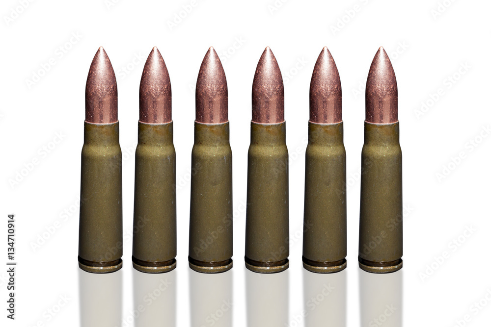 Bullets from kalasnikov rifle ammunition closeup isolated on white background.

