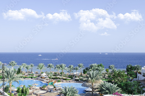 amazing view on the sea and shore with pools and palm trees