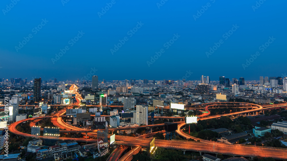Twilight sky over curved long exposure highway interchange in Bangkok downtown Thailand