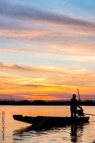 fishermen in boat on morning sunrise © PThira89