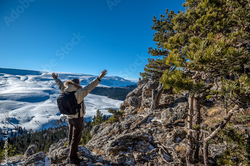 Hiker standing on edge of rock