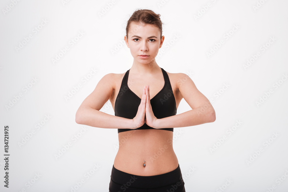 Portrait of a fitness pretty young woman with hands together Portrait of a fitness pretty young woman with hands together