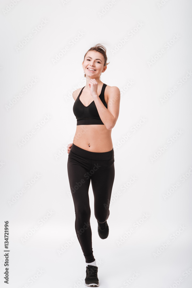 Full length portrait of a happy sports woman running Full length portrait of a happy sports woman running