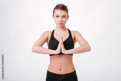 Portrait of a fitness pretty young woman with hands together