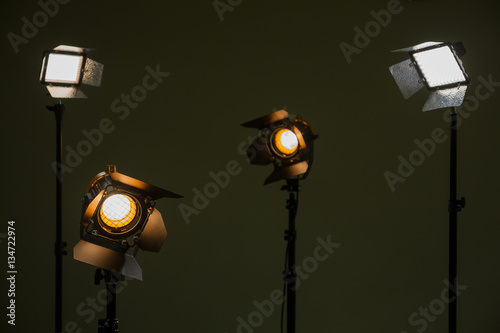 Halogen and led lights. Spotlights with Fresnel lenses. Studio photography. Photo and video shooting.