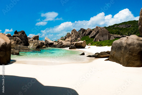 Natural pool on a tropical beach with huge rocks , Anse Marron, La digue, Seychelles © MandriaPix
