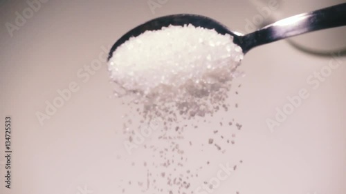 Slow mo in a cup of coffee is added to sugar
